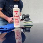 Collinite insulator wax no. 845 and man with a buffer working on a hood